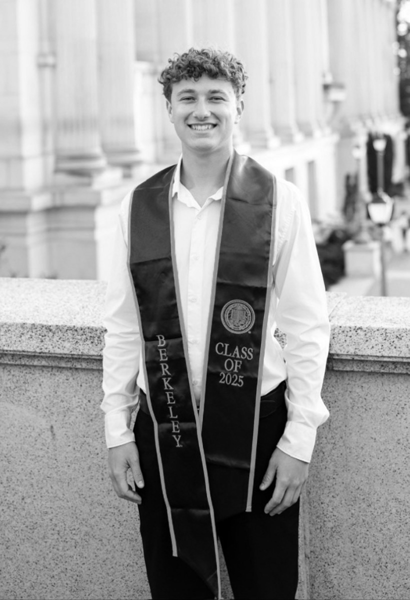 kai is at his UC berkeley graduation. he is a young man with short curly hair
